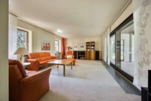 Heller Wohnbereich mit großen Fensterflächen und direktem Außenbezug
